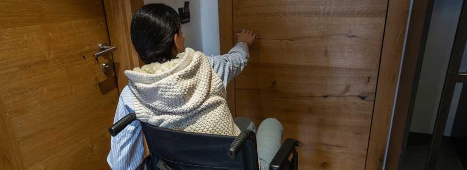 woman-in-wheelchair-opening-door